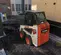 White, black and orange BOBCAT 600-850 lb. Skid Steer